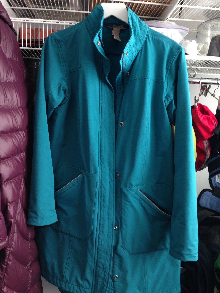 teal softshell rain coat on hanger