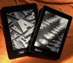 Two Kindle ebook readers, one labeled kids, the other says Mom's