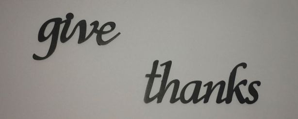 Wall art stating “Give thanks”