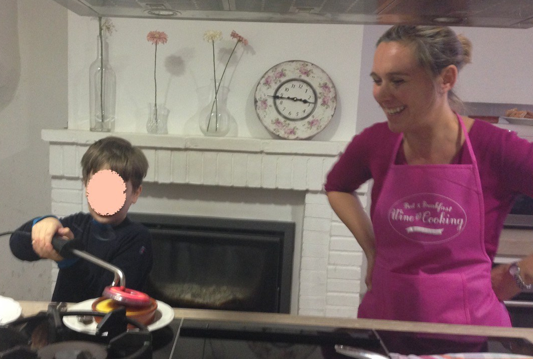 Boy carmelizing sugar atop Crema Catalana dessert