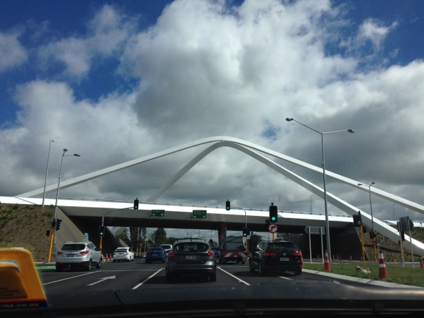 4 lane road passing beneath overpass