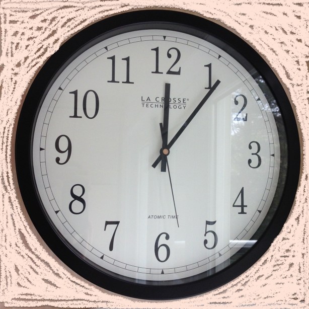 Analog wall clock showing 12:06