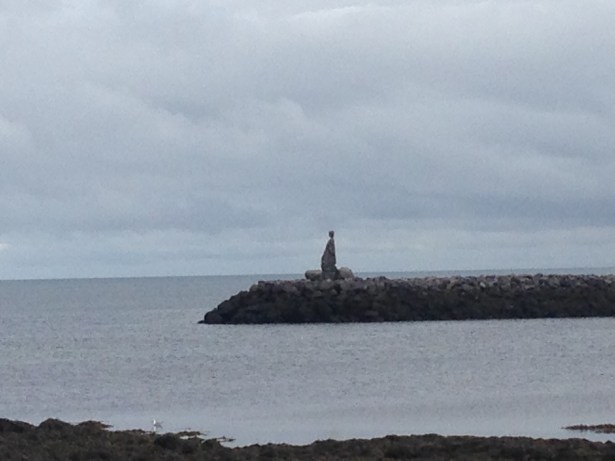 Vaguely humanoid stack of stones on a promontory in the North Atlantic Ocean