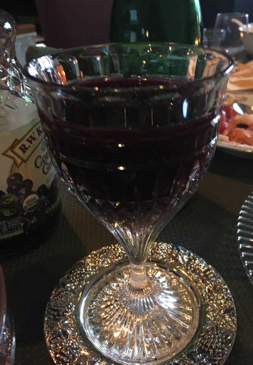 crystal goblet filled with wine on silver salver