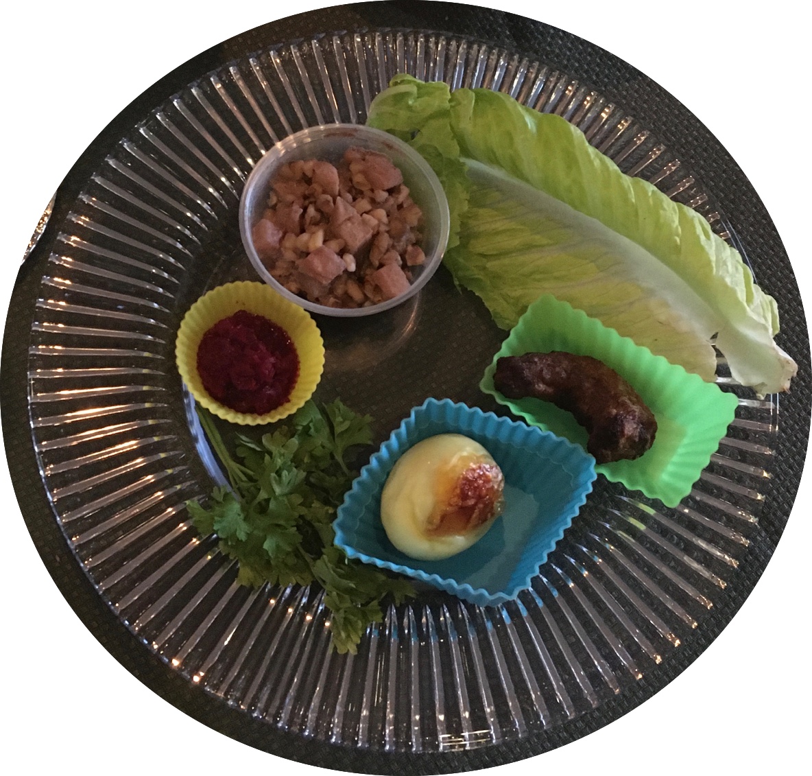 seder plate with bitter herbs, charoset, shank bone, etc.