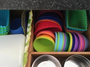 Several shapes of colorful silicone muffin cups stored in lunch packing drawer
