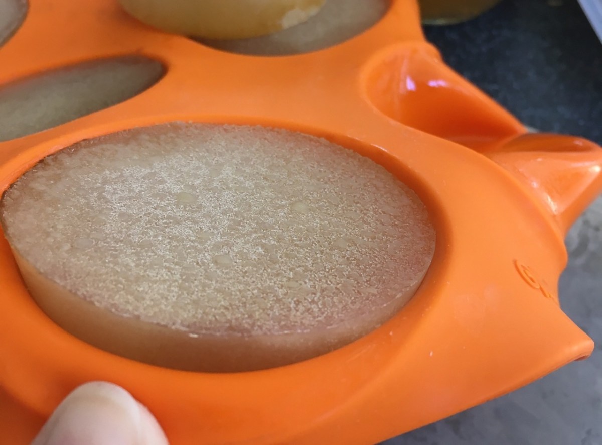 Frozen broth popping out of flexed silicone muffin tray