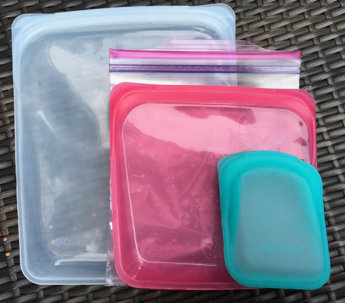 Large, medium & small Stasher silicone storage bags with quart size Ziploc bag to show size