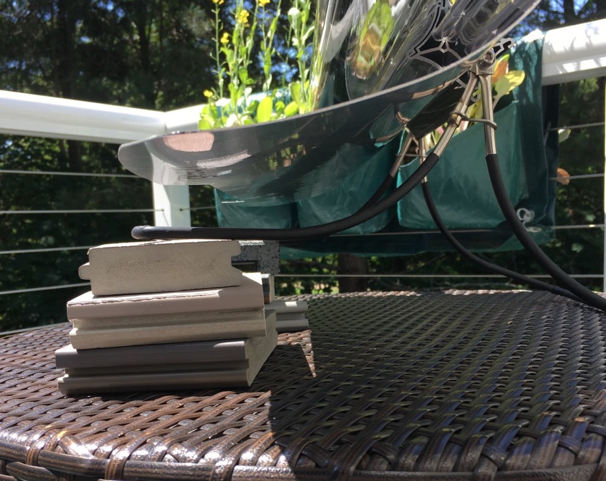 goSun Sport solar oven close up of legs in use, stacked on blocks to adjust angle to match sun