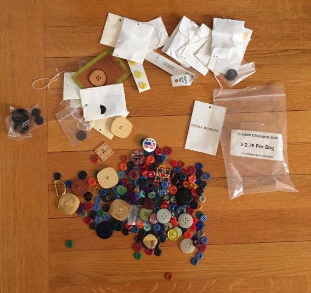 Dozens of buttons strewn across wood floor