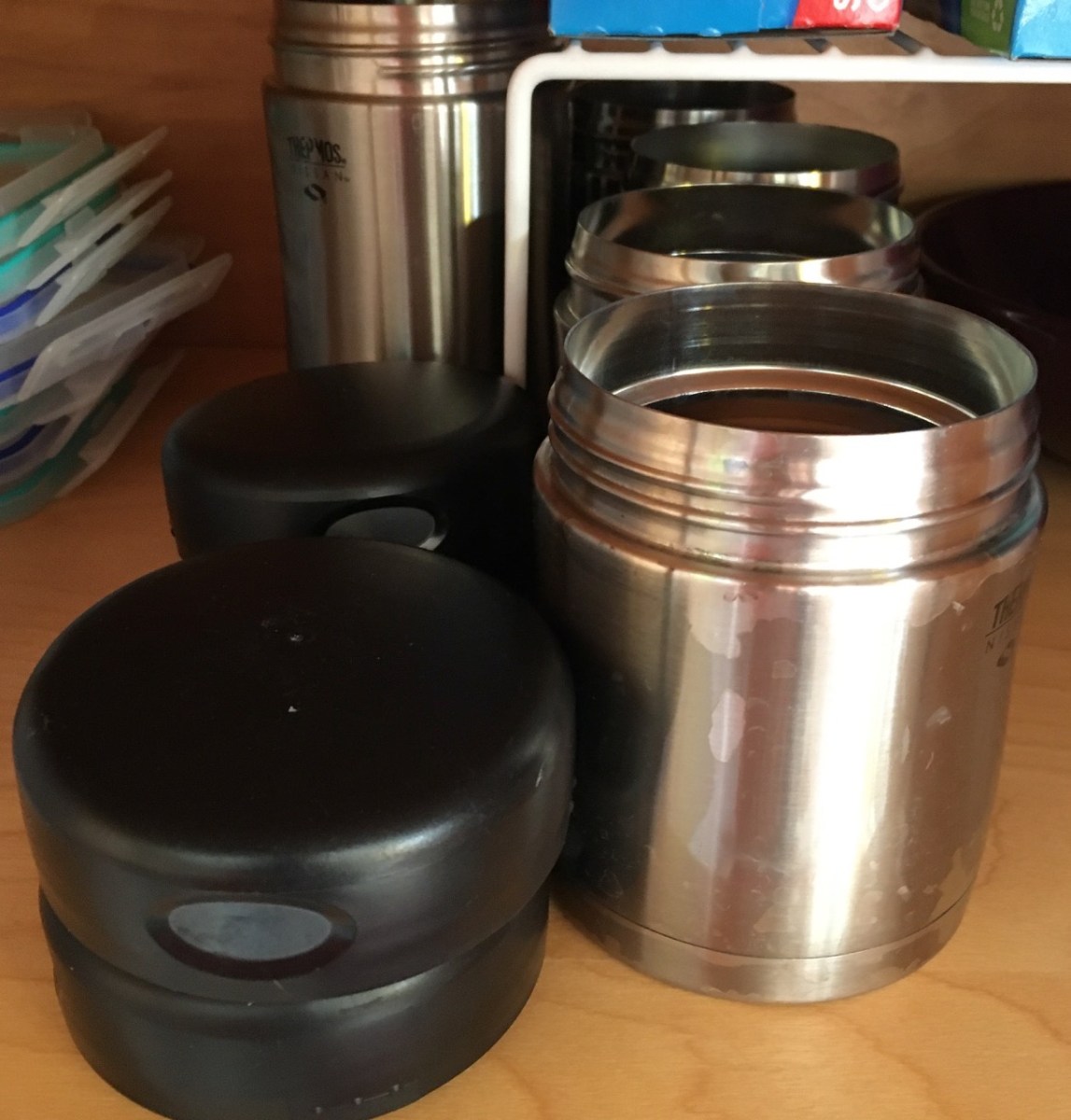 6 Thermos food jars in 2 sizes in cupboard, but only 4 lids