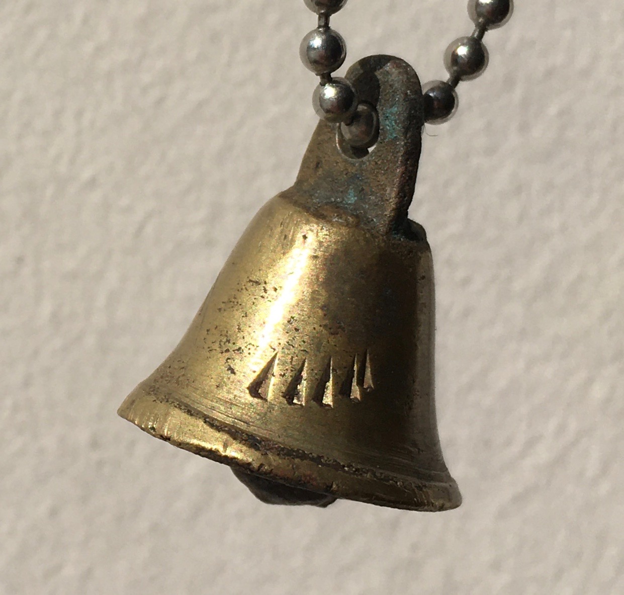 brass bell ringing on chain