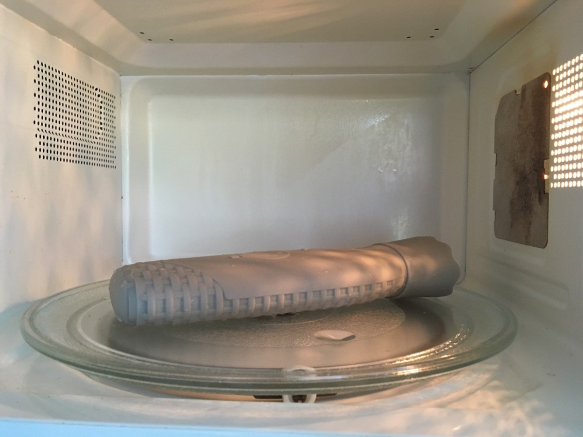 grey silicone hot water bottle on microwave turntable