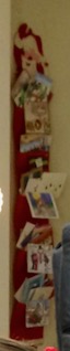 Red felt Santa wall display of Christmas cards, overflowing