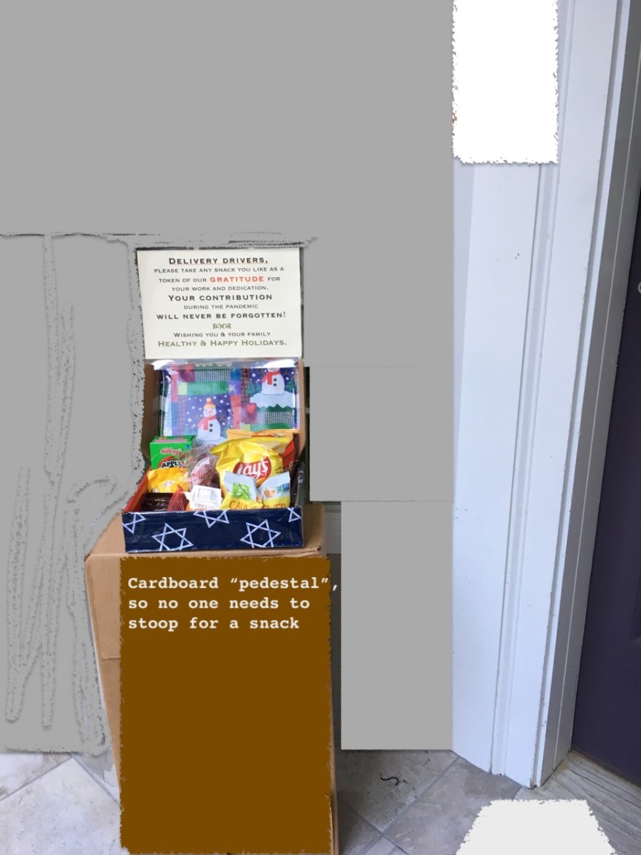 Snack box displayed by front door propped up on cardboard box