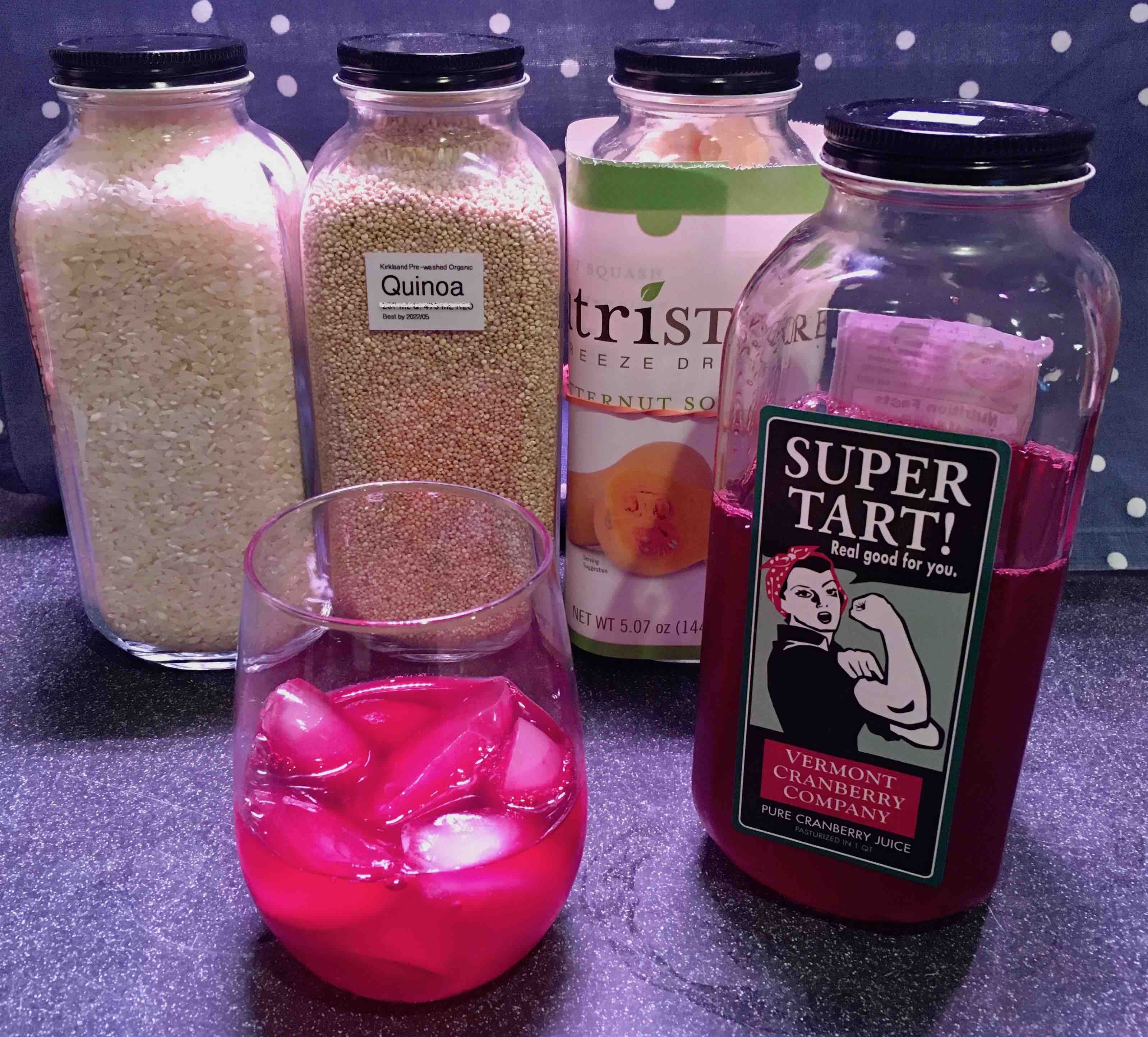 Super Tart! Cranberry Juice next to re-filled similar bottles with rice, quinoa, freeze dried dried squash