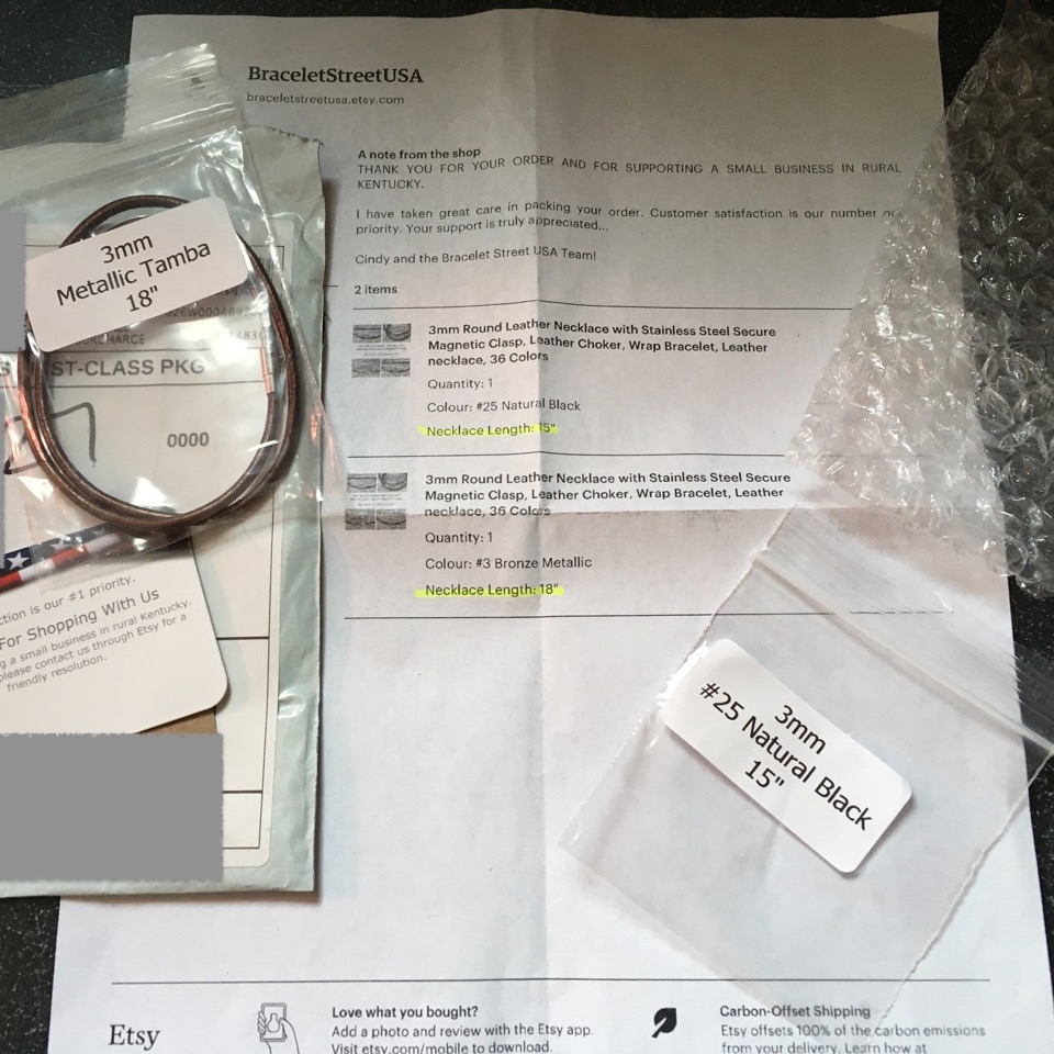 Necklace alongside invoice alongside simple yet adequate packaging from Bracelet Street USA