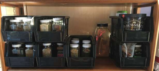 Wooden bookshelf with 7 AkroBins 30230 holding spice jars and other seasonings