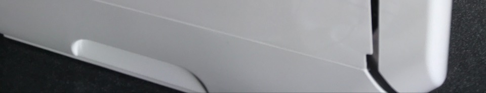 Close up of bottom edge of machine where divots make getting a grip easier