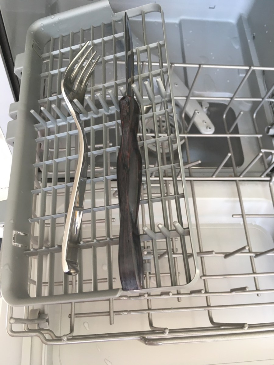 fork and steak knife on appliance's flat cutlery tray