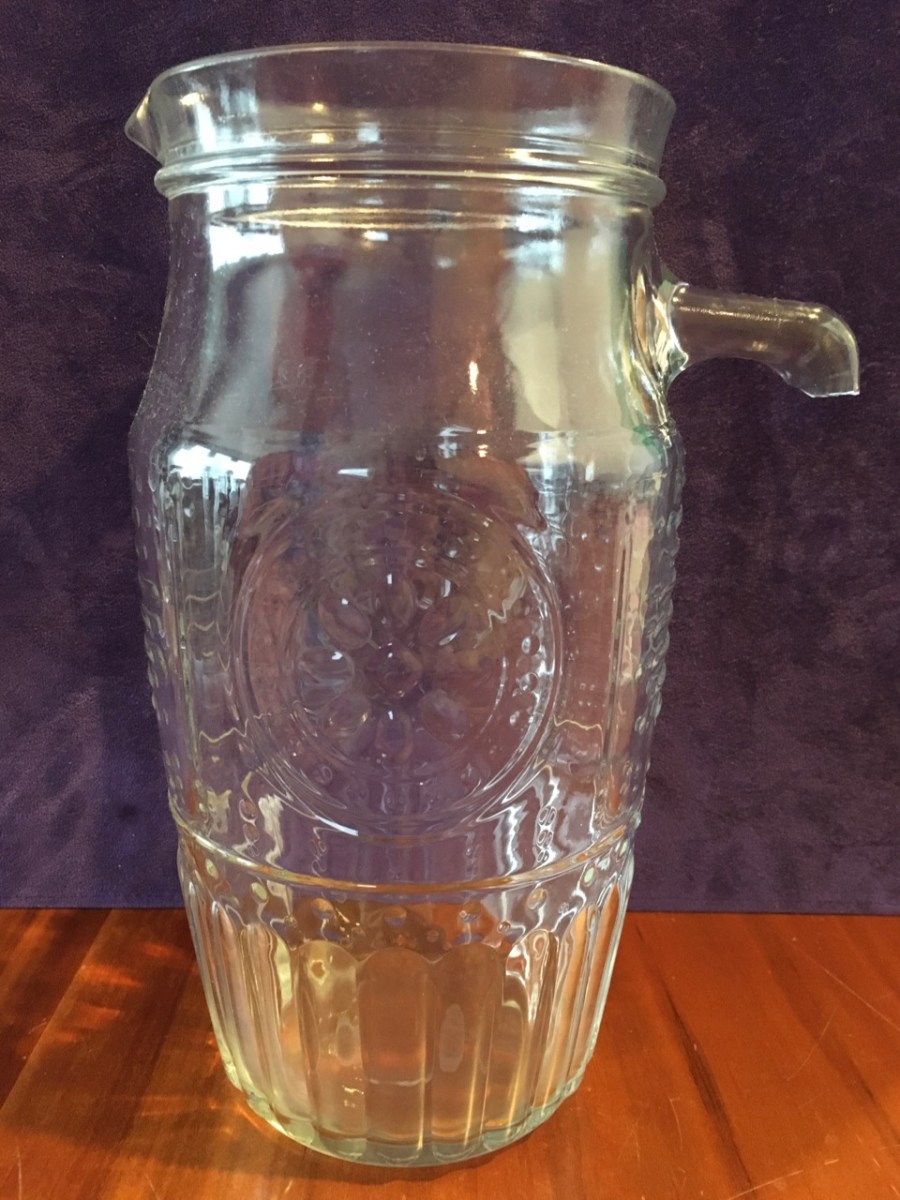 Patterned clear glass water pitcher with top stub only of broken off handle