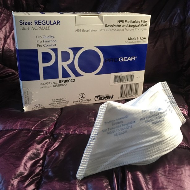 Unfolded ProGear N95 mask sitting in front box of 50 it came in