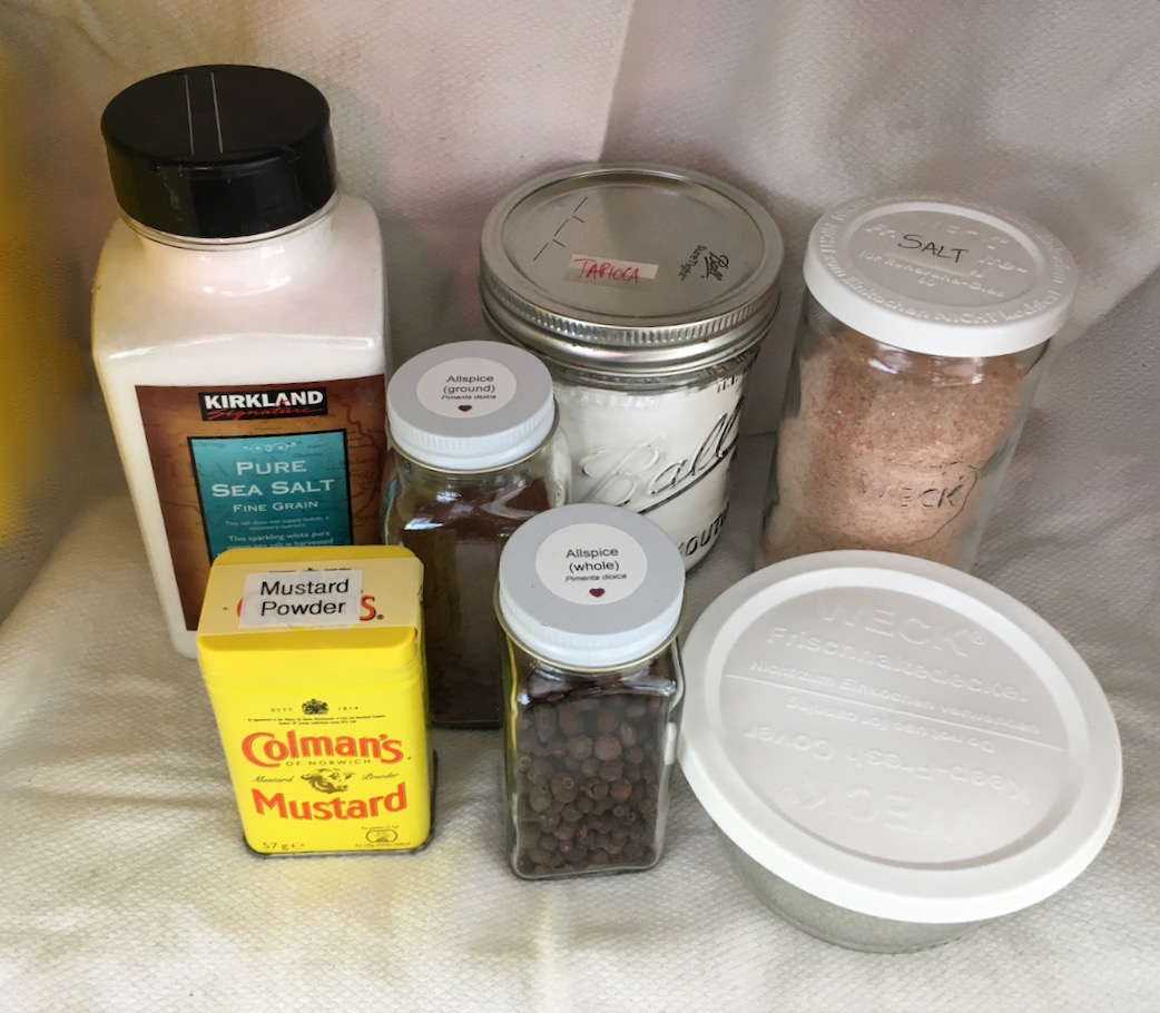 Kitchen seasonings in original packaging, Ball canning jar, tins, Weck jars, and home-labeled replacement bottles