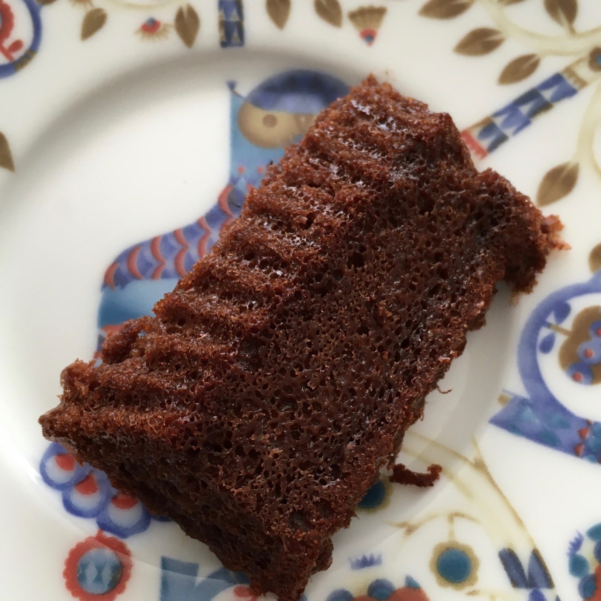 The same wonky mini cake dumped out of its mold upside-down on the dessert plate
