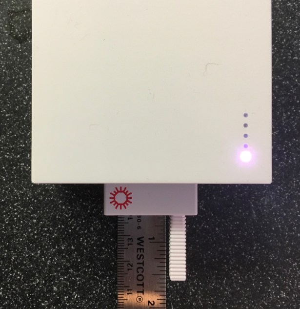 Ruler shows swab sticks out of cartridge about 1