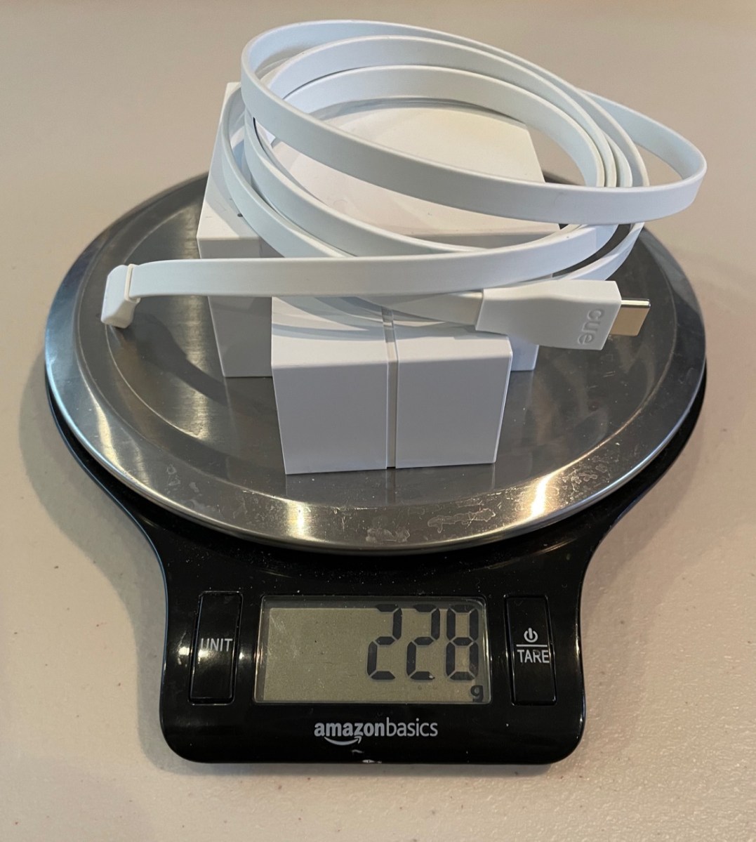 Cue Reader on scale with power cord and plug weighs 228 g