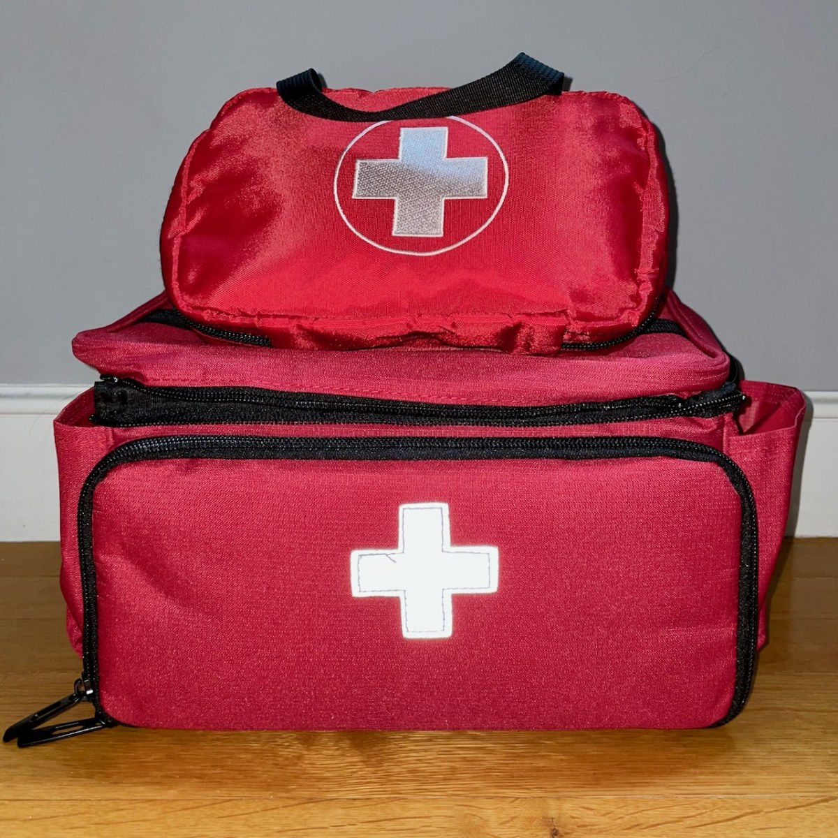 Tom Bihn First Aid Pouch on top of CURMIO bag, front view