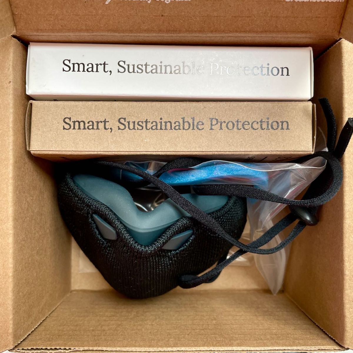 B2 mask carton with assemble mask and 2 boxes of filters fitting inside