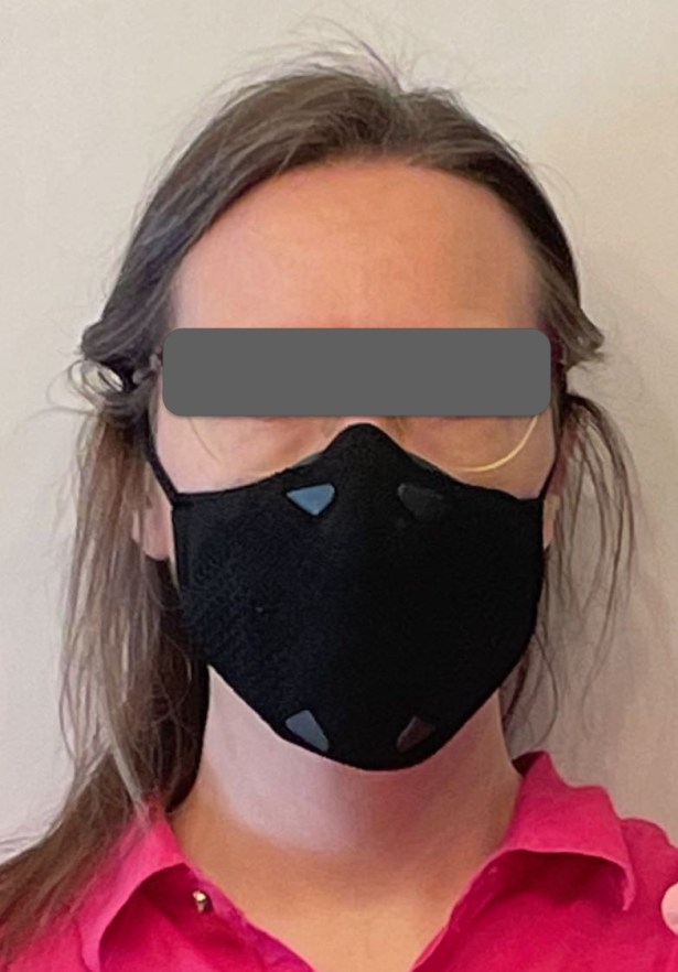 Woman wearing black B2 mask and glasses