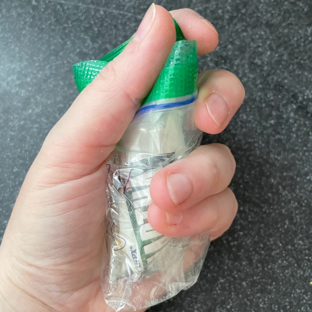 Baggie wrapped around Fels Naptha stump in wrapper in lady's closed fist