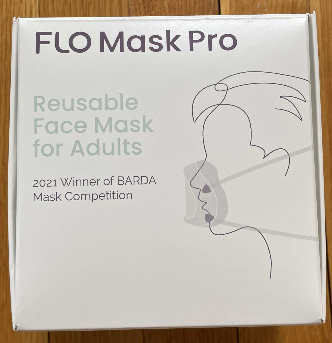 Top of FLO Mask Pro outer packaging, reusable face mask for adults, BARDA award winner 2021