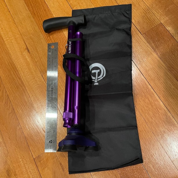 HurryCane next to ruler showing it is a few inches beyond 12" long folded