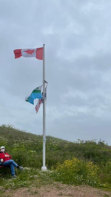 Canada and Labrador flags flying against overcast sky