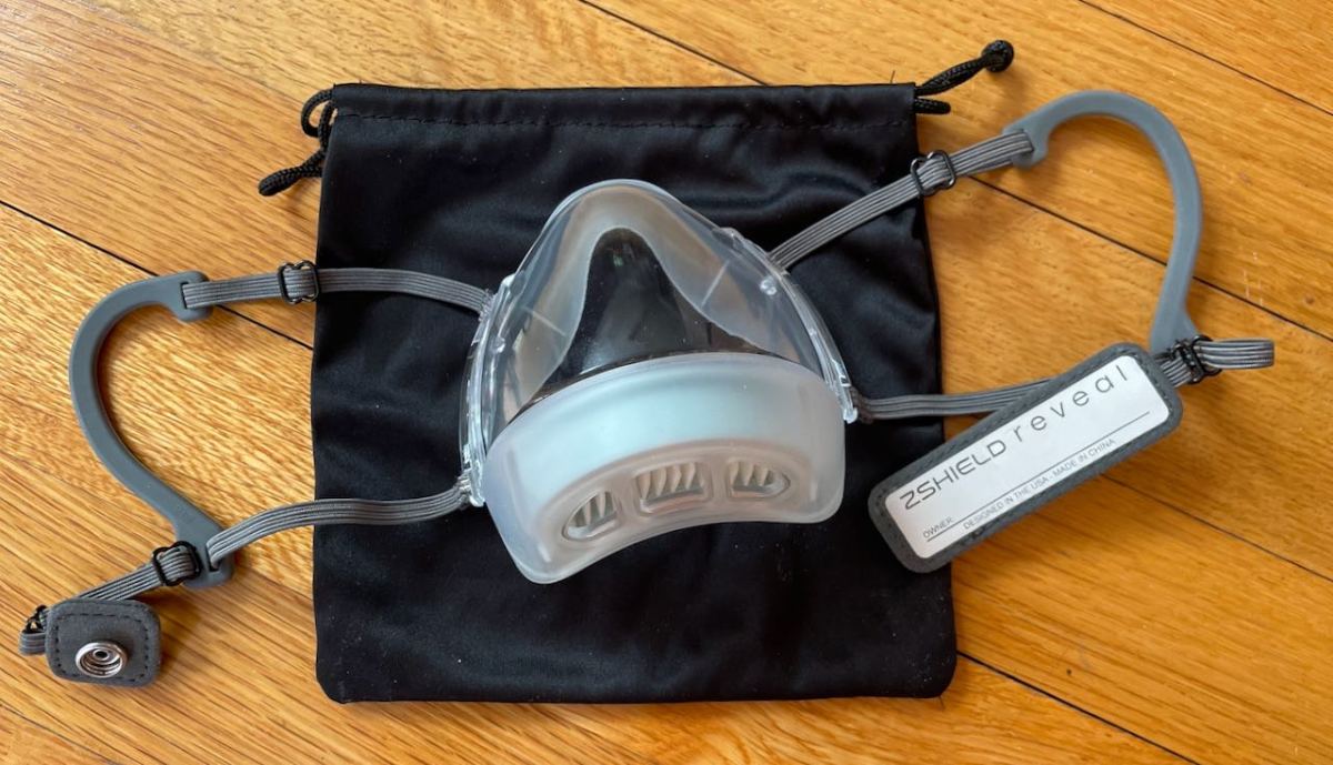 Ear loop mask with name label behind snap panel displayed