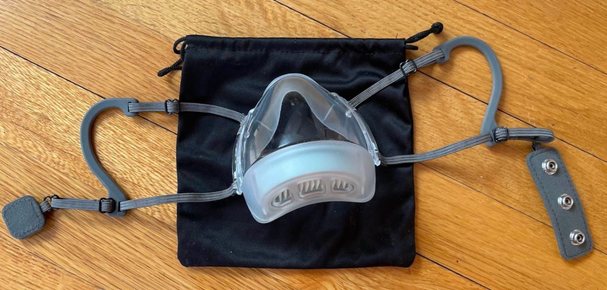 Ear loop mask with behind the head, snap-open restraining strap