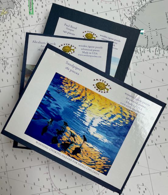 Stack of puzzle boxes with Sandpiper lid on top showing sea birds