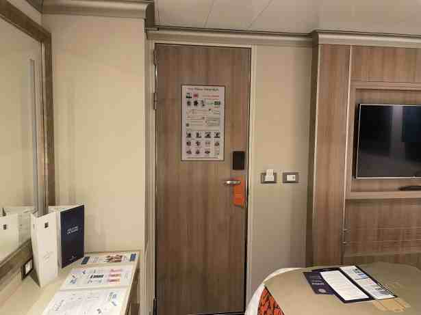 Door to corridor barely clears corner of bed when opened