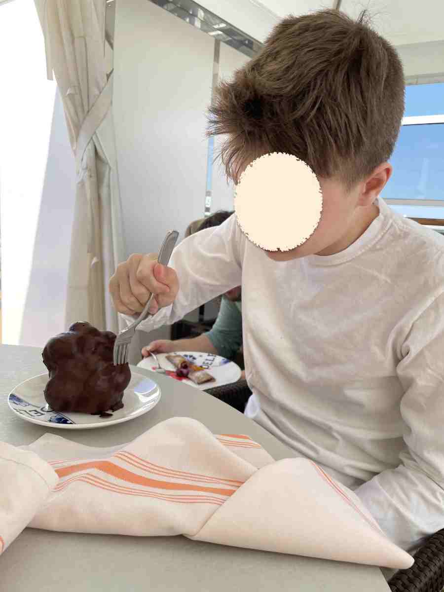 Teen eating giant creampuff dessert in Cabana