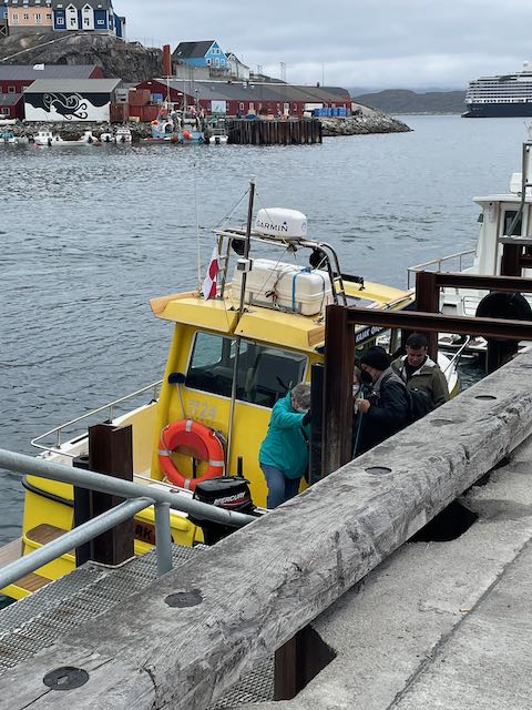 Small boat at the starting point for excursion, down 6-7 corrugated metal steps from dock