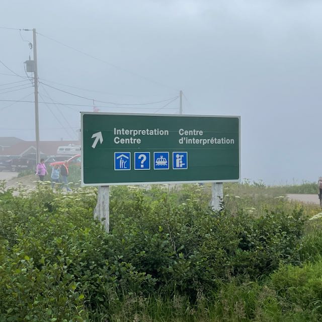 Green road sign indicating Interpretation Centre