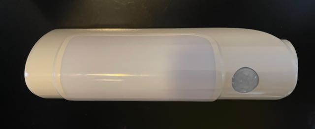 Rechargeable light magnetically affixed to filing cabinet switched off