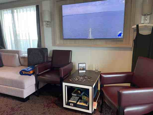 View of jigsaw puzzle in progress on coffee table with seating for four nearby