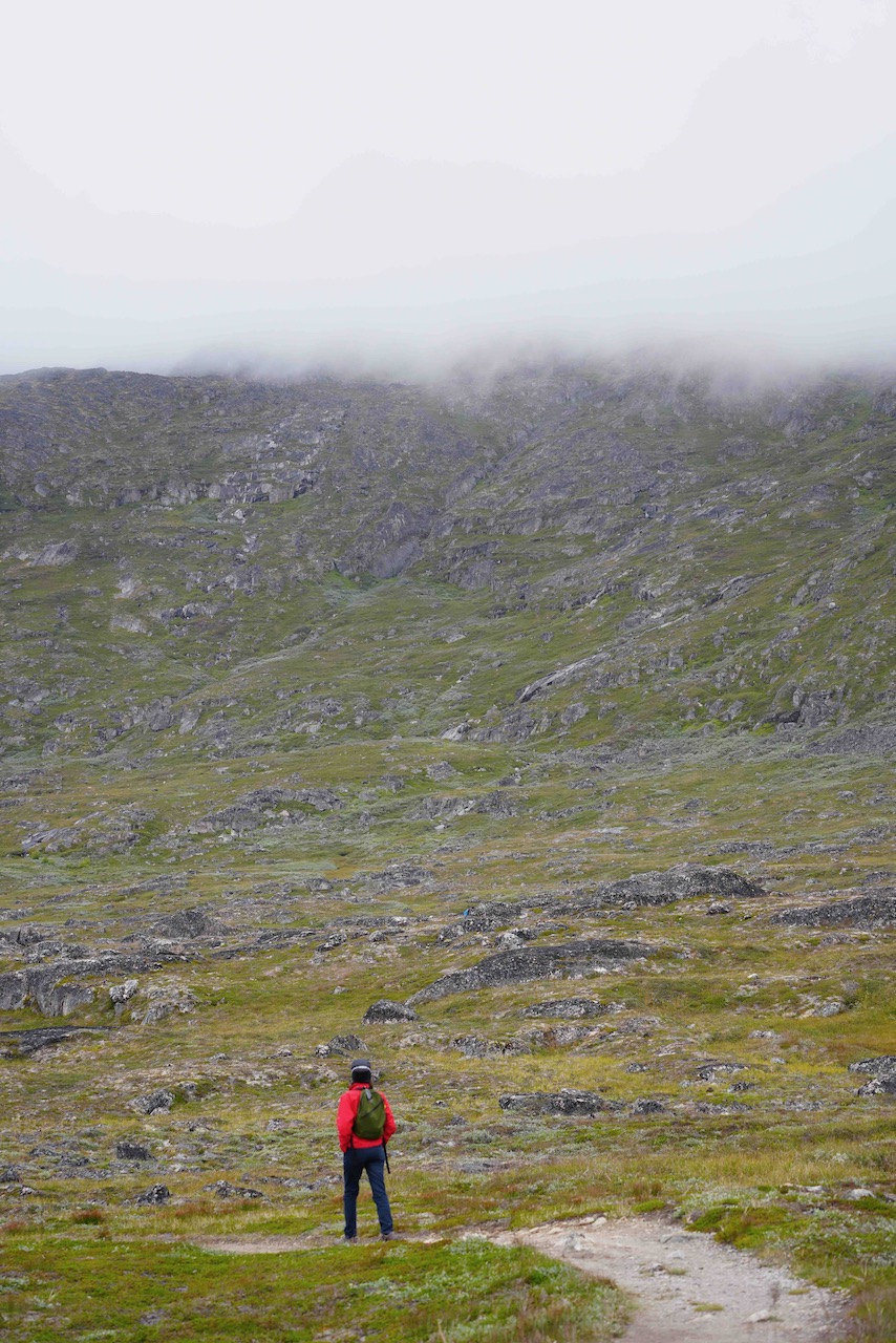 rock studded gravel and dirt path leading toward hills