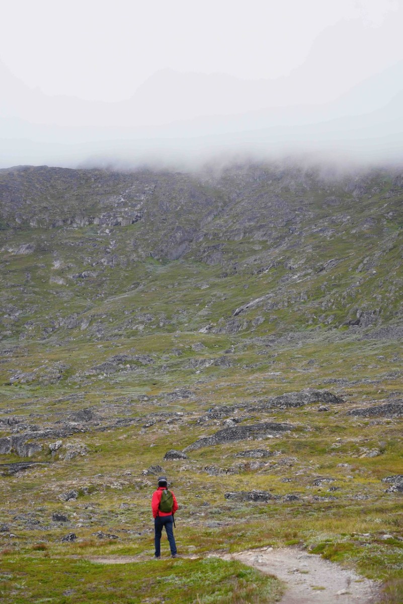 rock studded gravel and dirt path leading toward hills