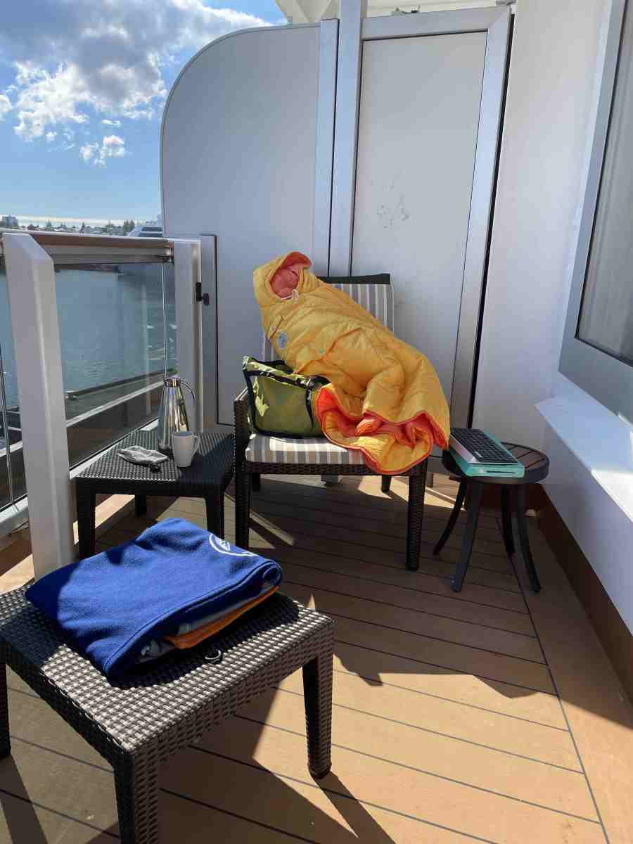 Yellow/orange Poler poncho on cruise ship balcony