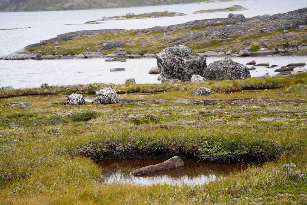 Boulders and pools surround Greenland lake